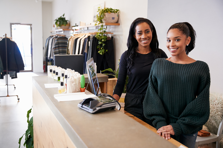 Bigstock Two Women Smiling Behind The C 220757470 